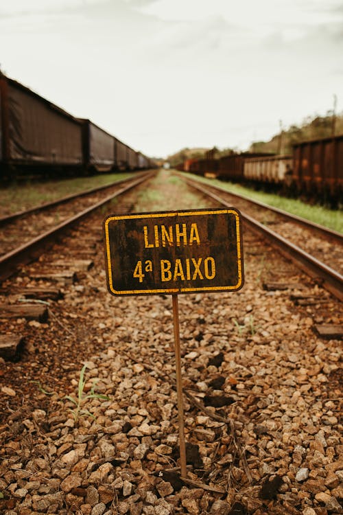A Railroad Sign on the Train Tracks 