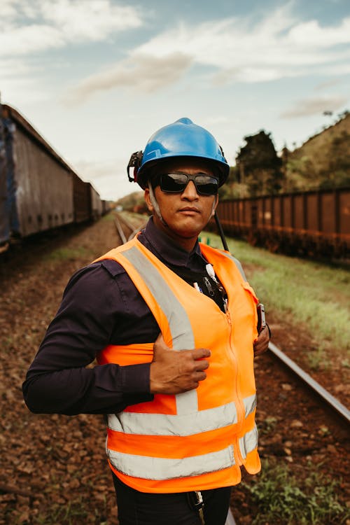 A Railway Worker Wearing a Safety Helmet and Safety Vest