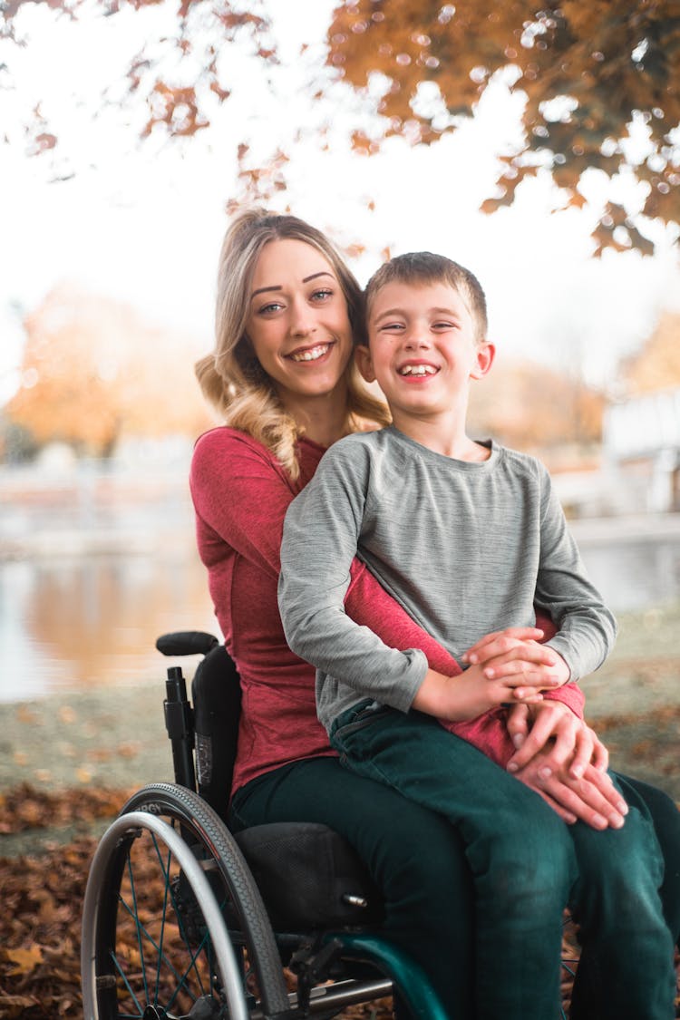 Cheerful Boy With Woman In Wheelchair