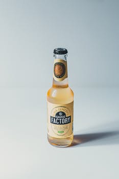 Close-up of a ginger flavored soda bottle on a white background.