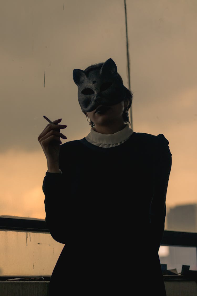 Person Wearing Mask Smoking Cigarette