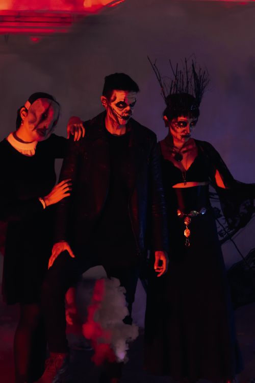 Free Group of people in eerie costumes and makeup for a Halloween or Dia de los Muertos celebration. Stock Photo
