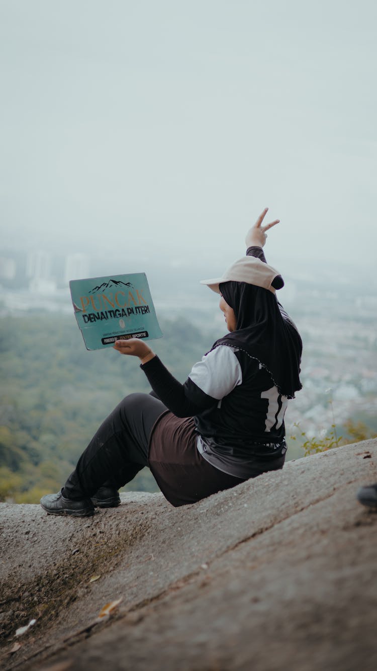 A Woman Sitting On A Rock 