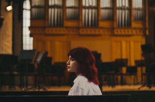 Side Portrait of a Young Woman on the Background of a Stage 