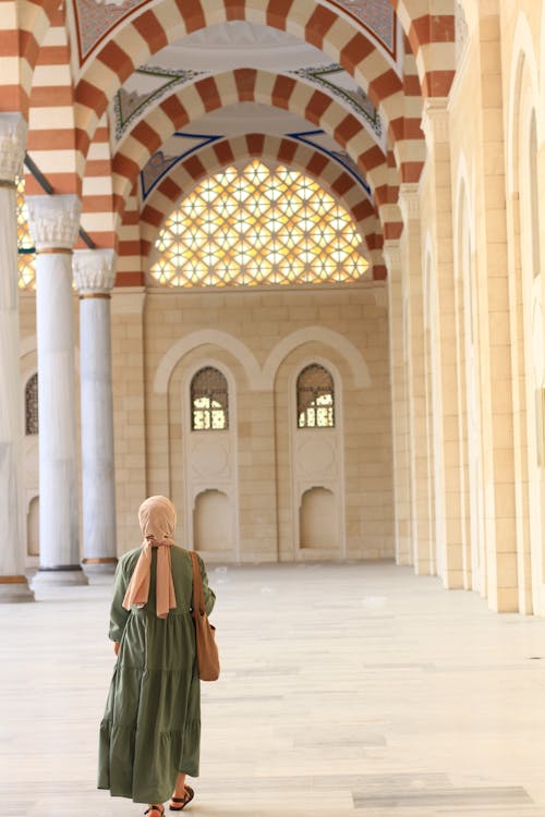 Woman Walking on Mosque Courtyard