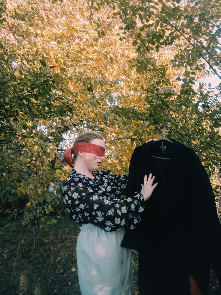 Woman With Eye Band Holding Clothes