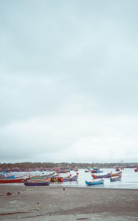 Boats Docked on a Shore under a Cloudy Sky · Free Stock Photo