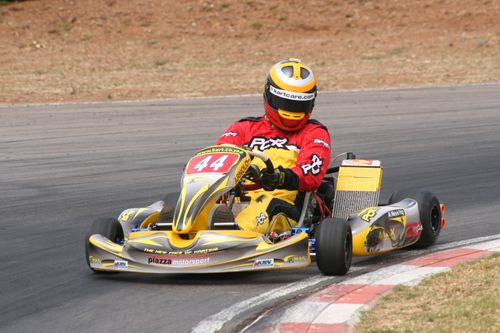 Free Go kart racer in action on a thrilling outdoor track in sunny weather. Stock Photo