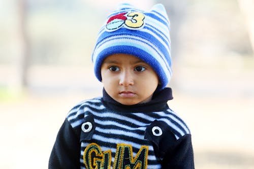 Close Up Photo of a Child Wearing Beanie