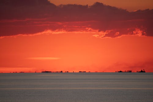 Ships on the Horizon under a Dramatic Pink Sky 