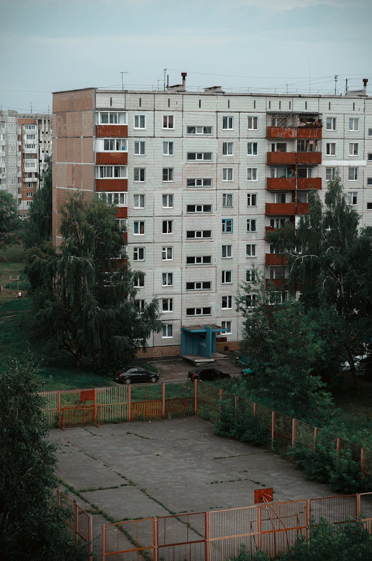 Basketball Ring Near Building With Apartments