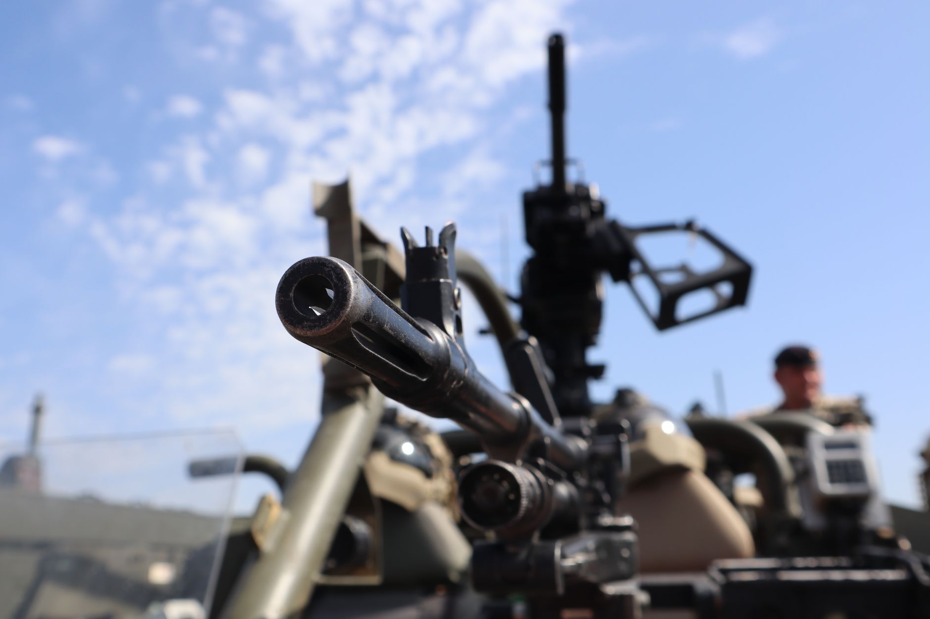 Detailed close-up of military equipment at Bovington exhibition, with focus on a machine gun.