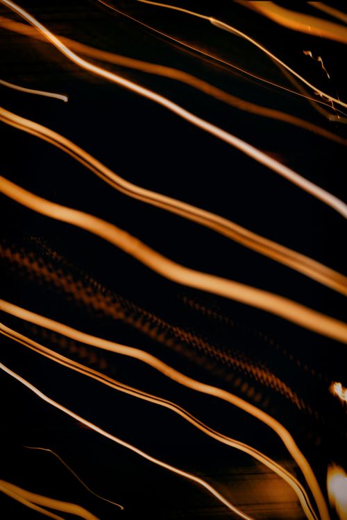 Free Energetic display of light streaks creating an abstract pattern on a dark backdrop. Stock Photo