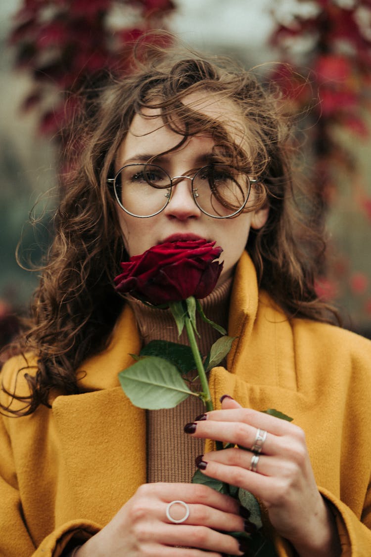 Young Woman Holding A Red Rose 