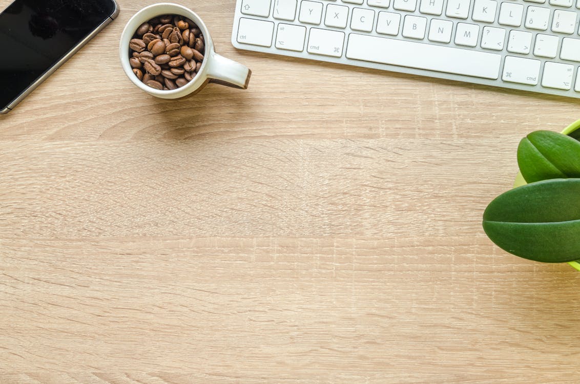 Coffee Beans in White Ceramic on Brown Wooden Table
