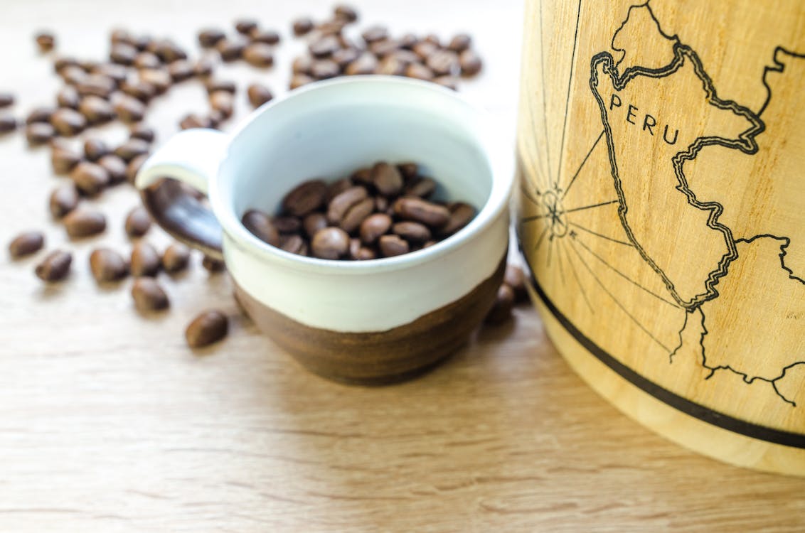 Free Round White and Brown Mug With Coffee Beans Stock Photo