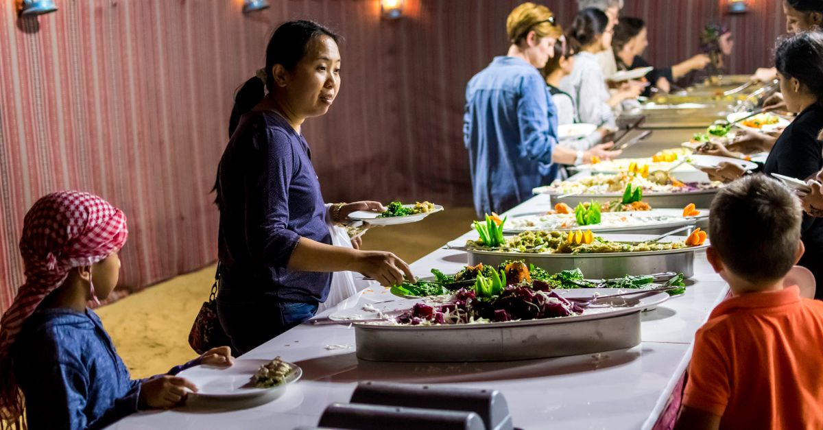 NTC Ho students enjoying a cultural food event with diverse dishes