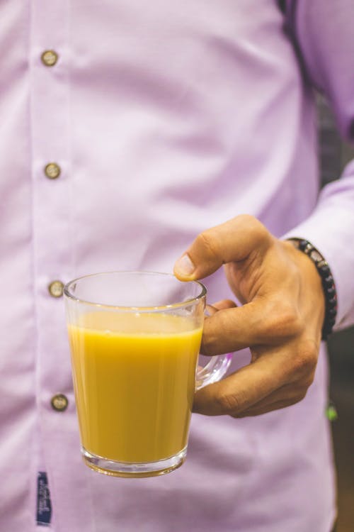 Free Person Holding Glass Mug Filled With Juice Stock Photo