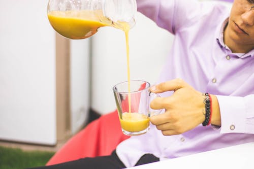 Man Pours Yellow Liquid