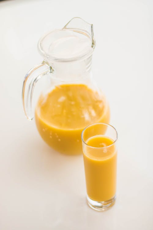 Free Pitcher And Drinking Glass Filled With Juice Stock Photo