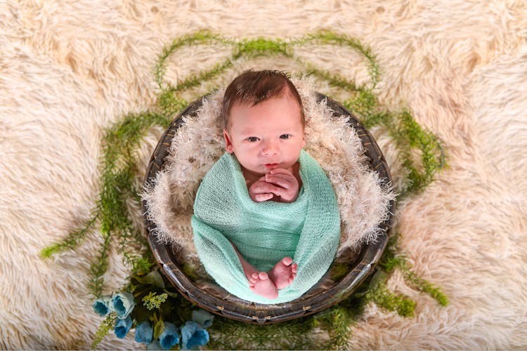 Baby Wrapped In Green Textile