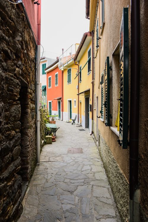 Free Charming narrow alley with vibrant houses showcasing European architecture. Stock Photo