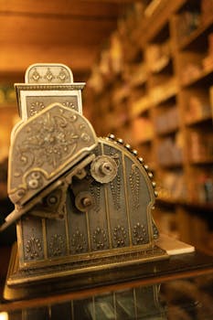 Close-up of a classic vintage cash register in an antique shop setting.