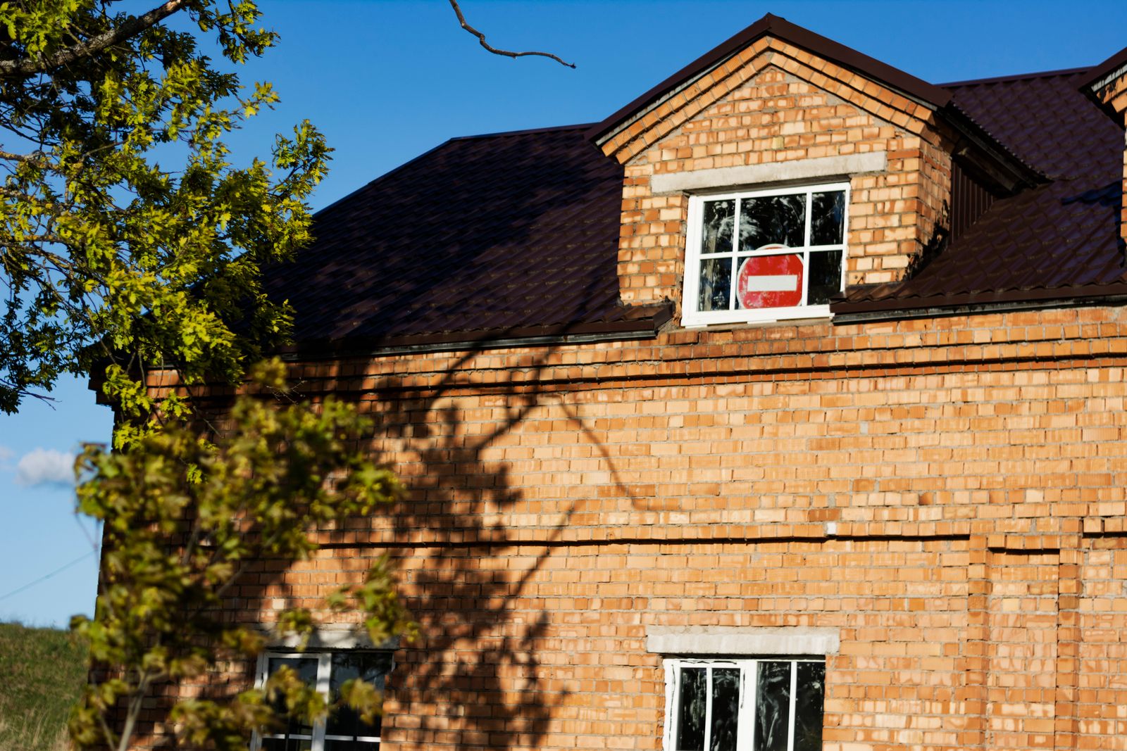 Detached brick house with clean slate roof