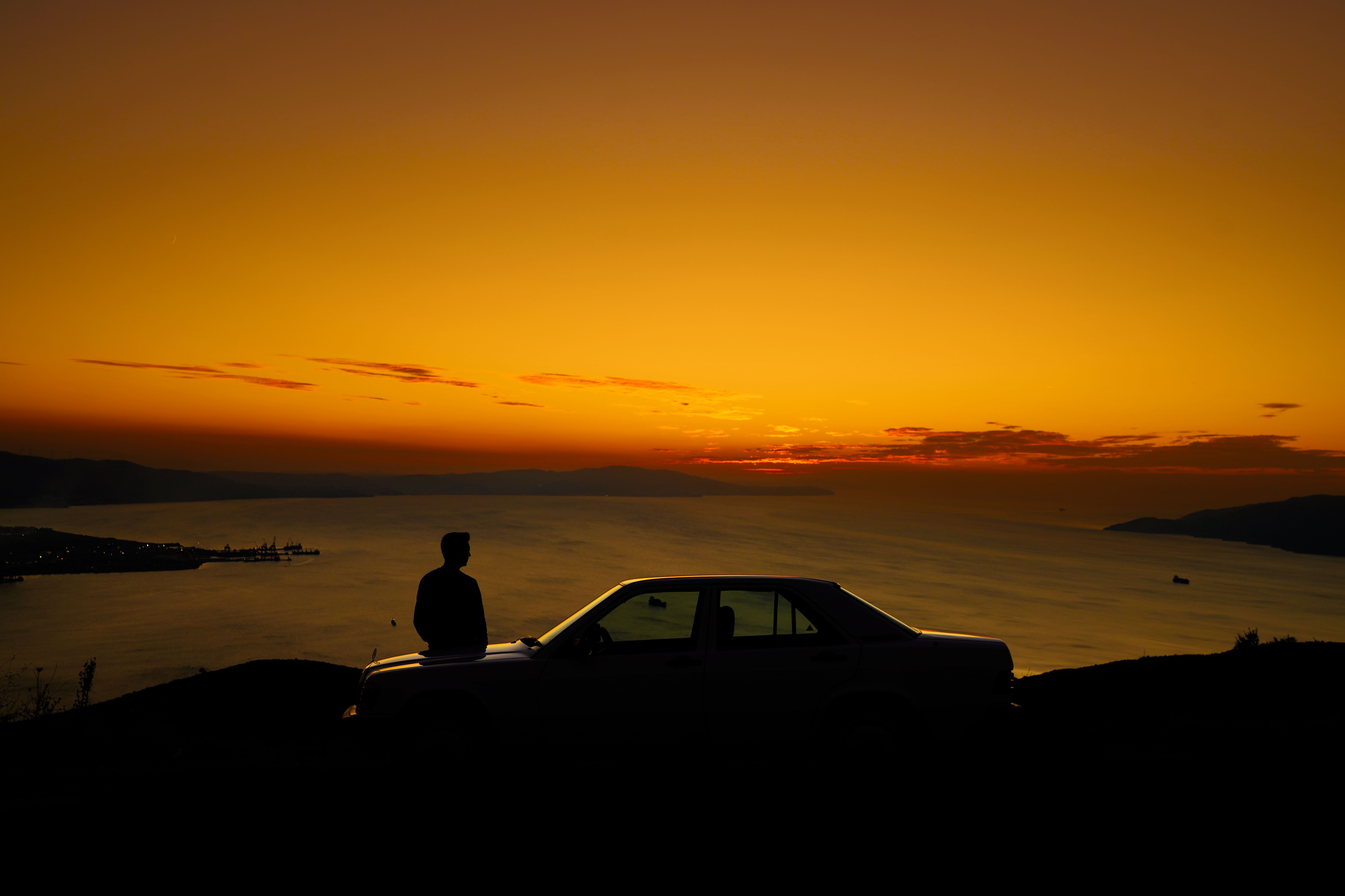 Silhouette of Mountain Near Body of Water · Free Stock Photo