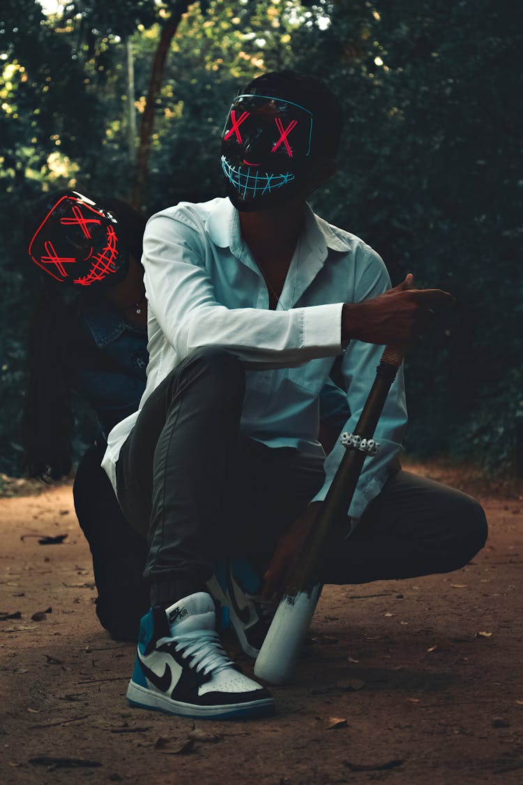 People In Spooky Masks With Baseball Bat