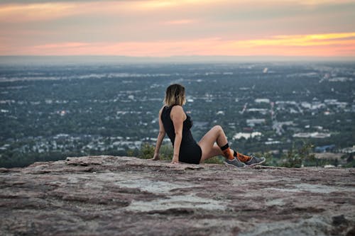 Woman Sitting On Rocks