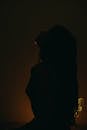 A Silhouette of a Woman in the Dark