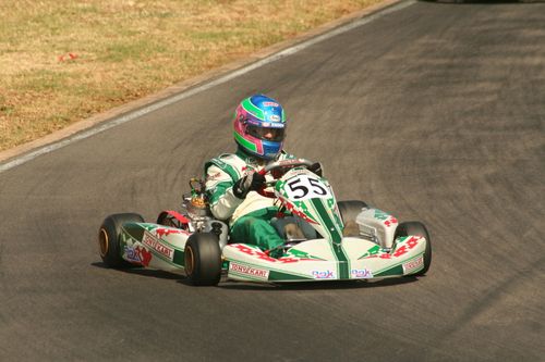 Free High-speed go-kart racing action featuring a driver maneuvering the track. Stock Photo