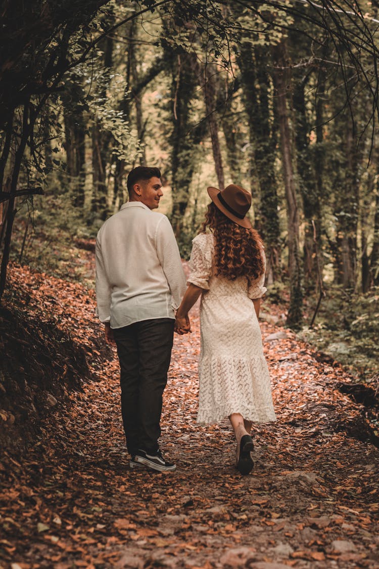 A Man And A Woman Walking In The Forest