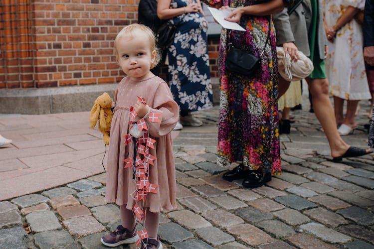 A Girl Holding A Toy 