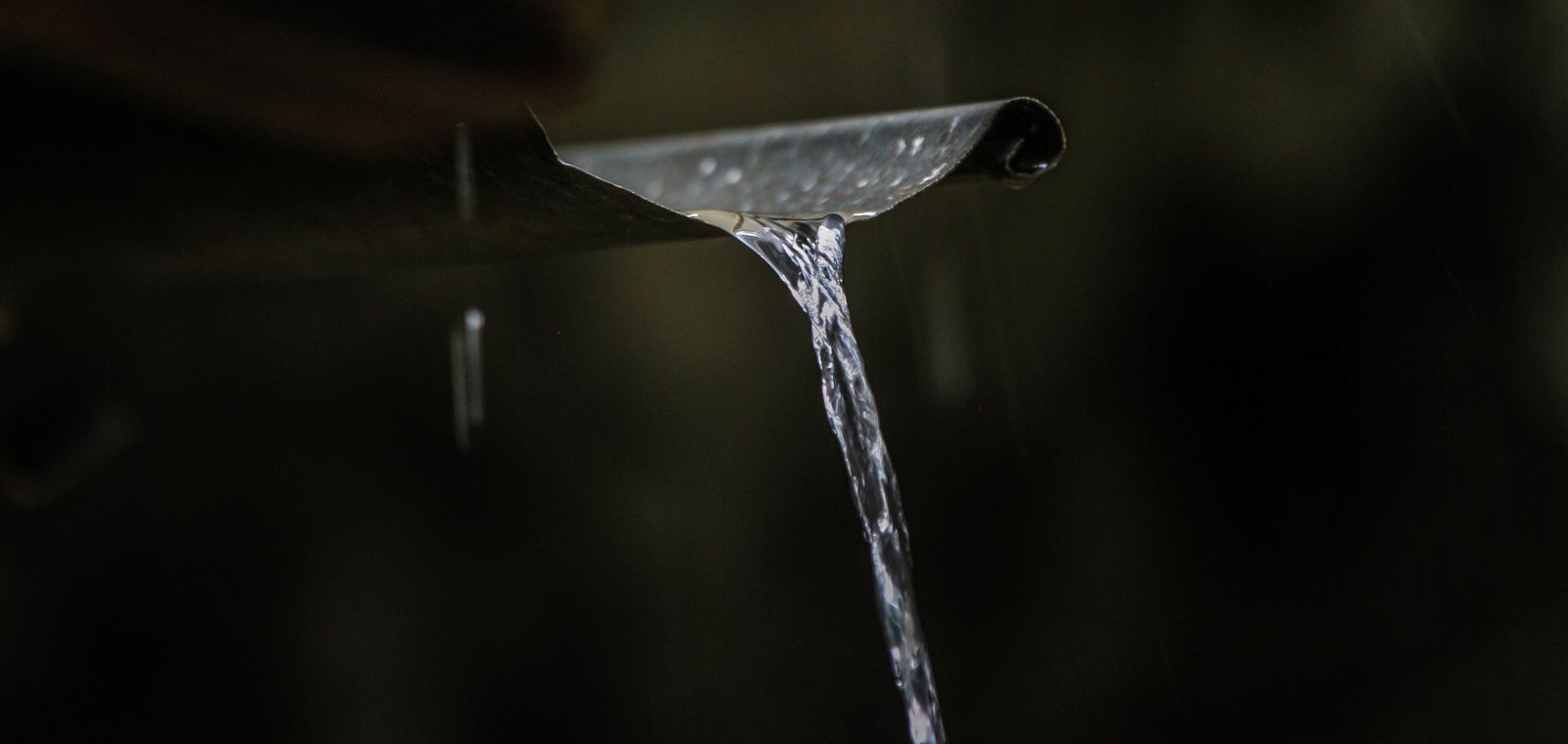 Rainwater spilling from a gutter