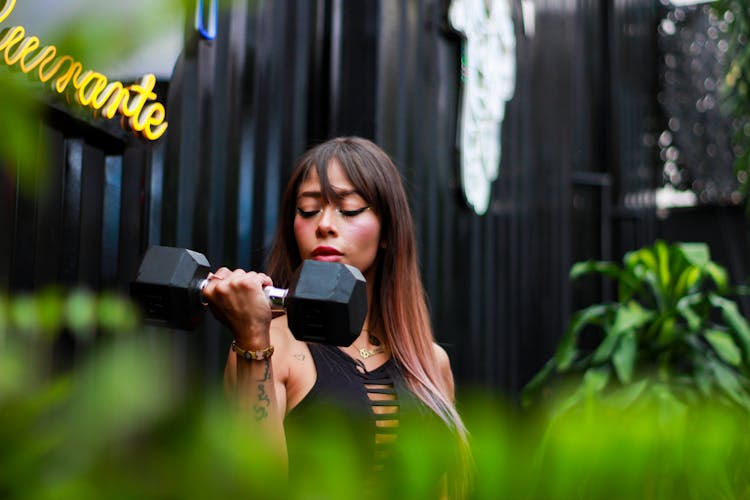 Woman Lifting A Dumbbell