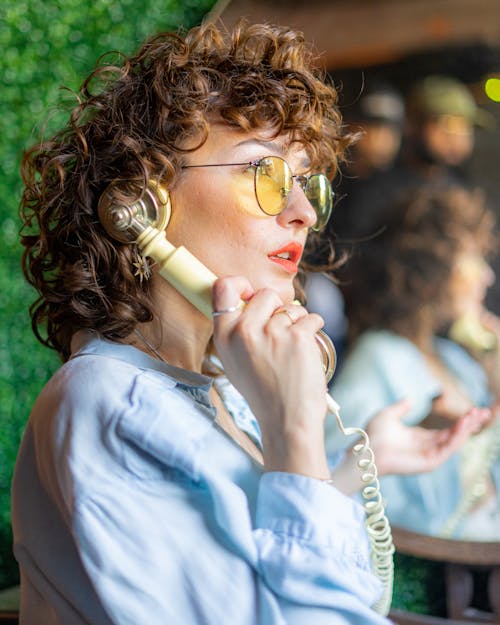 Woman in Eyeglasses and with Telephone Handset