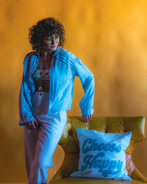 Woman Posing near Pillow on Armchair