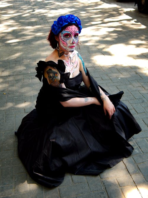 Catrina in Black Dress Sitting on Pavement