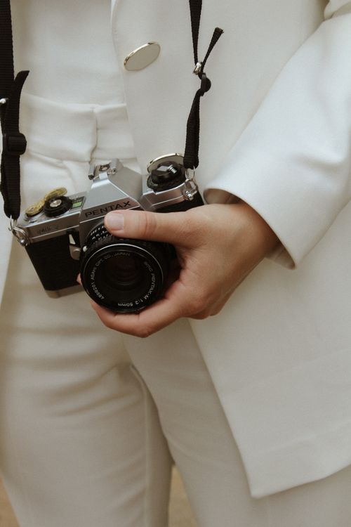 Free Close-up of a woman's hand holding a vintage camera, elegant and classic style. Stock Photo