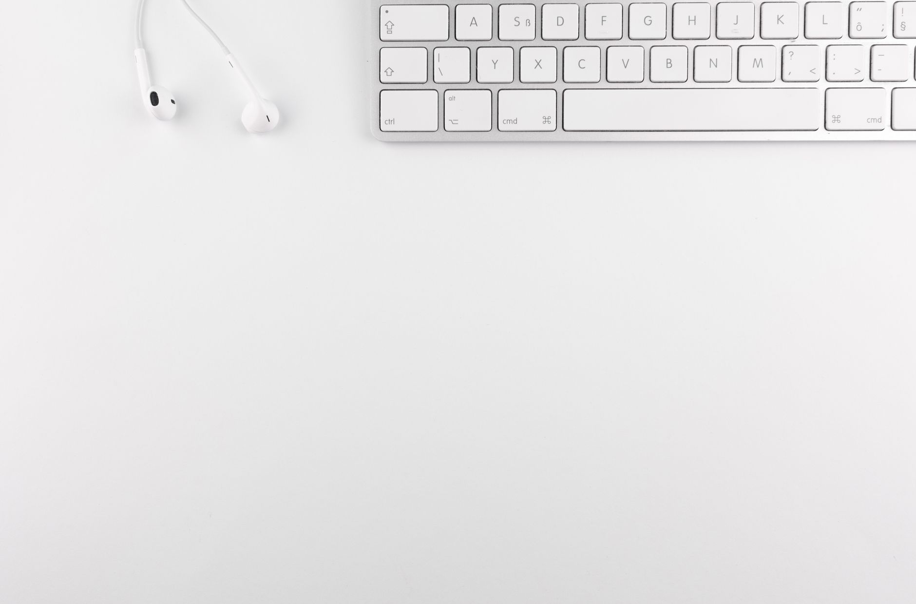 Top view of a white minimalist desk featuring a keyboard and earphones, ideal for technology themes.. pexels, view, white