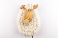 这款迷人的羊装饰品由羊毛和木材制成，非常适合用于装饰