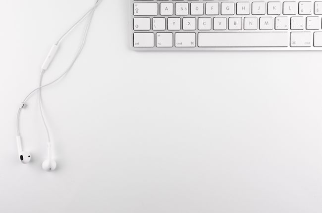 Earbuds resting on a light surface. Photo by Lukas Blazek on Pexels