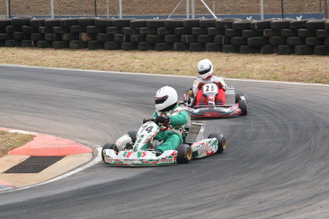 Drivers Racing in Go Karts on a Circuit · Free Stock Photo