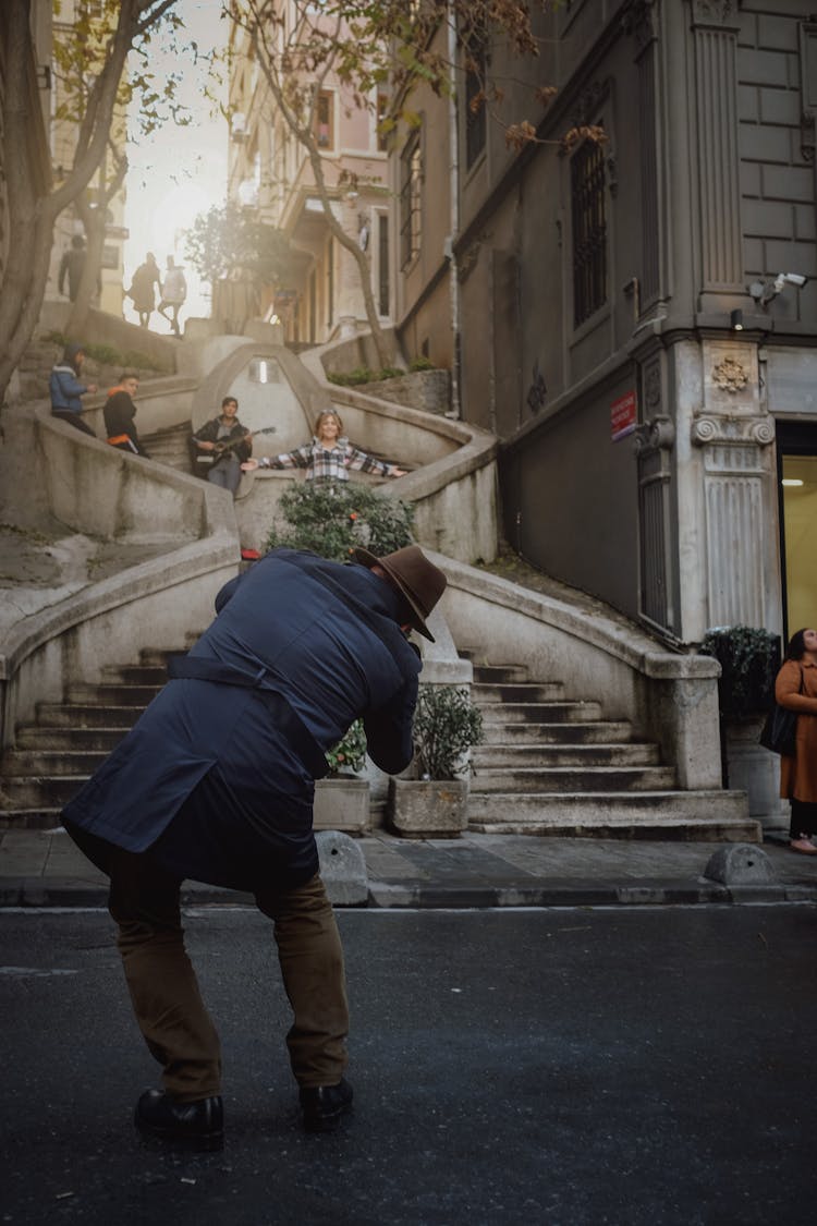 Photo Of A Man Taking Picture Of A Woman Posing On A Stairs