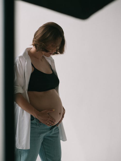Photograph of a Pregnant Woman Touching Her Belly