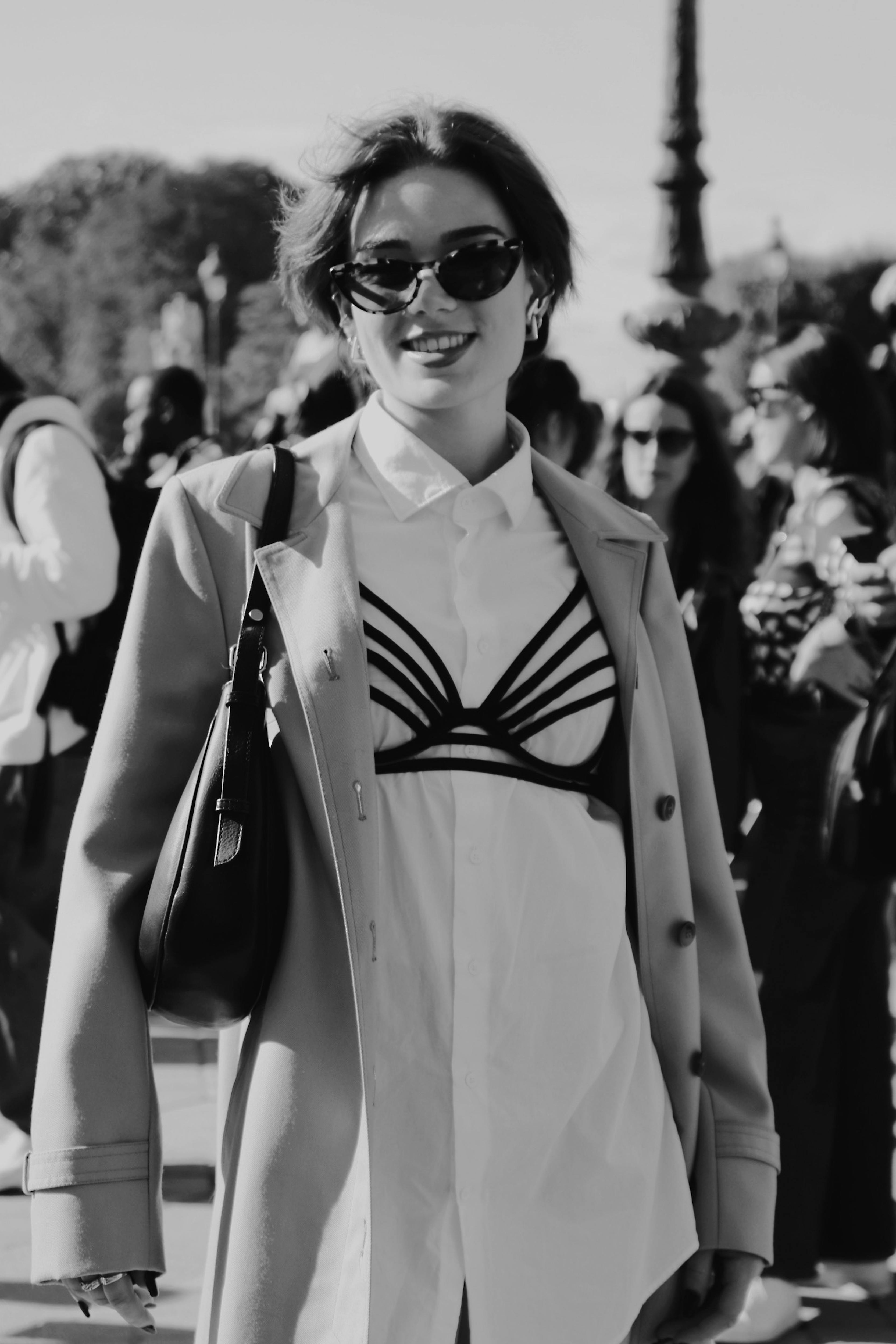 grayscale photo of woman in black sunglasses and white button up shirt