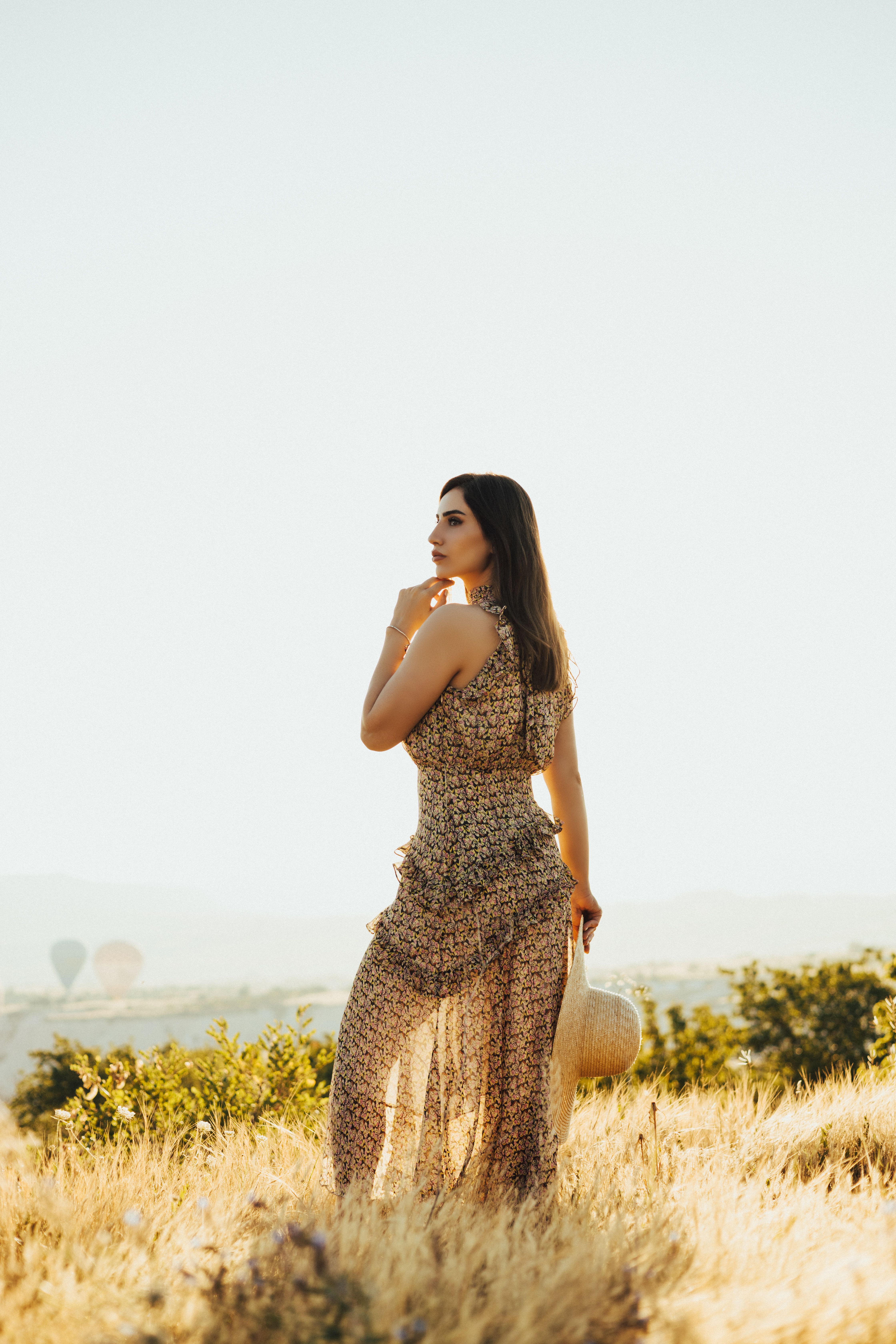 Brunette Woman in Long Summer Dress Standing in Grass · Free Stock Photo
