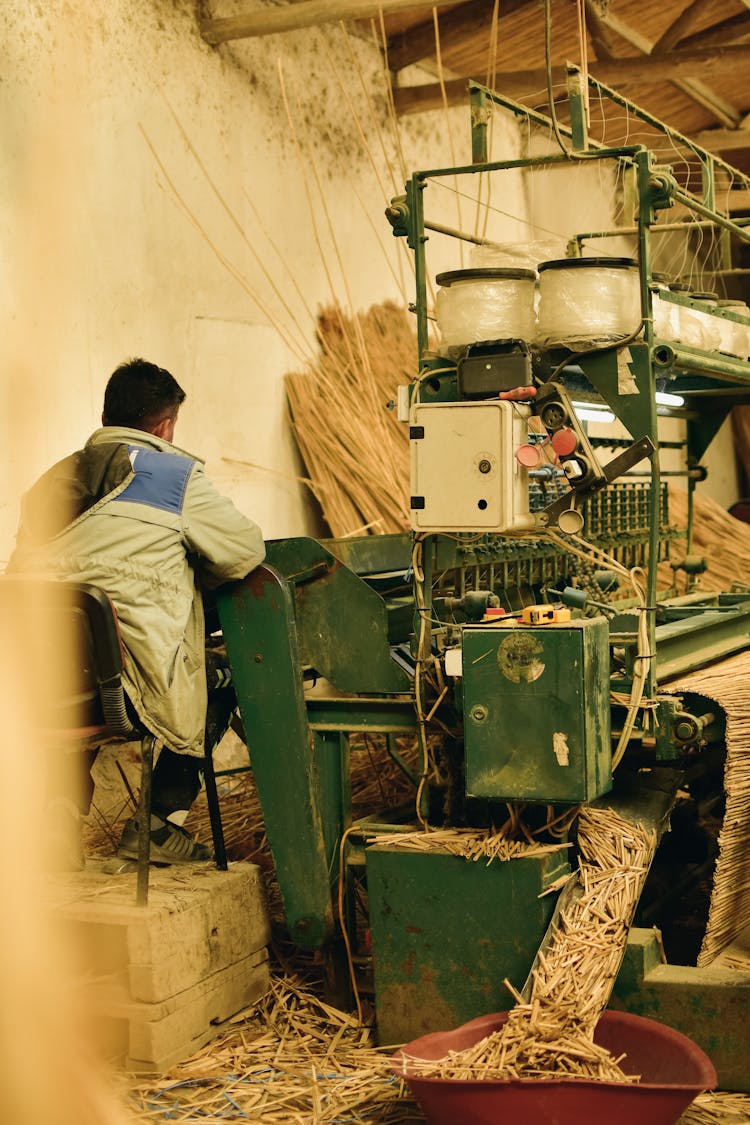 Man Working In Factory Operating Heavy Machinery